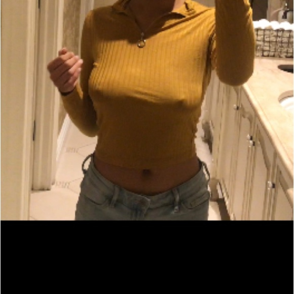 A mustard color crop blouses long sleeve with a zipper